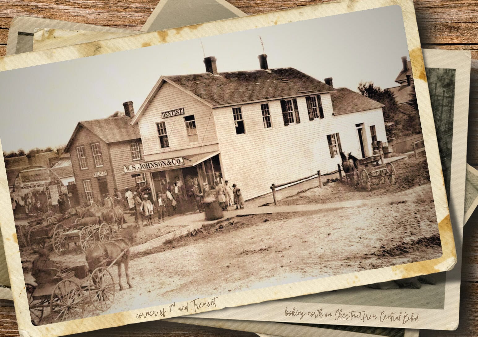 stack of old photos, the top displayed picture is the buildings on the corner of second st and tremont st taken before 1900 in Kewanee